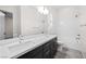 Modern bathroom with double sinks, sleek vanity, and tiled shower-tub combination at 717 Monroe Hill Pl, Henderson, NV 89011