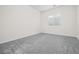 This bedroom features plush gray carpet, white walls, and a window with white shutter blinds at 717 Monroe Hill Pl, Henderson, NV 89011