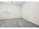 Bright bedroom features soft carpet, window with plantation shutters, and neutral paint at 717 Monroe Hill Pl, Henderson, NV 89011