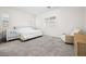Neutral bedroom with a queen bed, white shutters, gray carpet, and a compact crib at 717 Monroe Hill Pl, Henderson, NV 89011