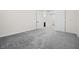 A neutral bedroom features gray carpet and leads to a bright hallway at 717 Monroe Hill Pl, Henderson, NV 89011