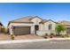 Charming single-story home with a tile roof, two-car garage, and well-maintained landscaping at 717 Monroe Hill Pl, Henderson, NV 89011