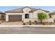 Elegant single-story home featuring a tile roof, two-car garage, and desert-friendly landscaping at 717 Monroe Hill Pl, Henderson, NV 89011