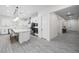 Open concept kitchen with large island, stainless appliances, and white cabinetry at 717 Monroe Hill Pl, Henderson, NV 89011