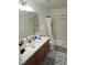 Well-lit bathroom features a single sink vanity, shower-tub combination, and marble flooring at 7461 Enviable Ct, Las Vegas, NV 89149