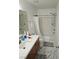 Bright, well-lit bathroom with vanity, bathtub-shower combination and marble tile flooring at 7461 Enviable Ct, Las Vegas, NV 89149