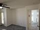 Bedroom features plush carpet, a ceiling fan, and access to the hallway at 7461 Enviable Ct, Las Vegas, NV 89149