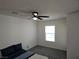 This bedroom features neutral carpet, a ceiling fan, and a bright window at 7461 Enviable Ct, Las Vegas, NV 89149