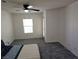 Cozy bedroom with plush carpeting, ceiling fan, and a door to the balcony at 7461 Enviable Ct, Las Vegas, NV 89149
