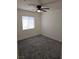 Bright bedroom with neutral paint, carpet flooring, and large window offering ample natural light at 7461 Enviable Ct, Las Vegas, NV 89149