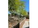 Landscaped community area showcasing a decorative fence, lush trees, and inviting pedestrian walkways at 7461 Enviable Ct, Las Vegas, NV 89149