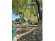 The beautifully landscaped community park features shady trees, a walking path, and common picnic area at 7461 Enviable Ct, Las Vegas, NV 89149