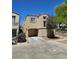 Well-kept two-story house featuring an attached garage, neutral exterior paint, and tidy landscaping on a sunny day at 7461 Enviable Ct, Las Vegas, NV 89149