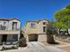 Well-maintained two-story house featuring an attached garage, neutral exterior paint, and tidy landscaping on a sunny day at 7461 Enviable Ct, Las Vegas, NV 89149