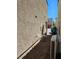 Home exterior showing yard, HVAC, and access path along side of house in a suburban neighborhood at 7461 Enviable Ct, Las Vegas, NV 89149