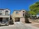 Charming two-story home with tan stucco, an attached garage, and well-maintained landscaping at 7461 Enviable Ct, Las Vegas, NV 89149