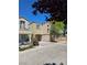 Well-maintained two-story house featuring an attached garage, neutral exterior paint, and tidy landscaping on a sunny day at 7461 Enviable Ct, Las Vegas, NV 89149