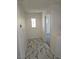 Hallway features marble tile flooring and a view into a carpeted room at 7461 Enviable Ct, Las Vegas, NV 89149