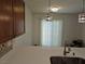 Open kitchen layout with island sink, pendant lights, and sliding glass door to the outdoor area at 7461 Enviable Ct, Las Vegas, NV 89149