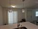 Contemporary kitchen with white countertops, stylish pendant lights, and a view to the dining area at 7461 Enviable Ct, Las Vegas, NV 89149