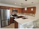 Well-lit kitchen featuring stainless steel appliances, a breakfast bar, and pendant lighting at 7461 Enviable Ct, Las Vegas, NV 89149