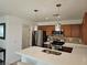 Modern kitchen with stainless steel appliances, tile backsplash, and elegant pendant lighting at 7461 Enviable Ct, Las Vegas, NV 89149