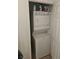 A compact laundry area with a stacked washer and dryer unit at 7461 Enviable Ct, Las Vegas, NV 89149