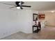 A staged living room adjacent to kitchen, offering tiled flooring and ample natural light at 7461 Enviable Ct, Las Vegas, NV 89149