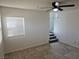 This living room features a ceiling fan, neutral paint, and staircase leading to the next level at 7461 Enviable Ct, Las Vegas, NV 89149