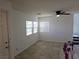 Inviting living room with lots of natural light, neutral paint, and stylish ceiling fan at 7461 Enviable Ct, Las Vegas, NV 89149