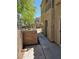 Patio between townhomes showcasing stucco walls, wrought iron fencing, and sidewalk at 7461 Enviable Ct, Las Vegas, NV 89149