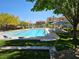 A refreshing community pool surrounded by lounge chairs, manicured lawns, and inviting cabanas for relaxation at 7461 Enviable Ct, Las Vegas, NV 89149