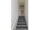 Carpeted staircase leading to the upper level features a handrail and neutral paint at 7461 Enviable Ct, Las Vegas, NV 89149
