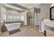 Relaxing bathroom with a standalone tub, walk-in shower, and vanity area at 7492 Midfield Ct, Las Vegas, NV 89120