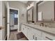 Elegant bathroom featuring dual sinks, quartz countertops, and a shower and tub combination at 7492 Midfield Ct, Las Vegas, NV 89120