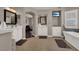 Large bathroom featuring double vanities, a soaking tub, and a walk-in shower at 7492 Midfield Ct, Las Vegas, NV 89120