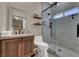 Contemporary bathroom featuring walk-in shower with sliding glass door and floating shelves at 7492 Midfield Ct, Las Vegas, NV 89120