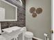 Modern half-bathroom with wood-look accent wall, a stylish vanity, and tasteful decor at 7492 Midfield Ct, Las Vegas, NV 89120