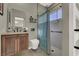 Modern bathroom featuring walk-in shower with blue shower curtain, floating shelves and wood cabinets at 7492 Midfield Ct, Las Vegas, NV 89120