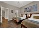 Bedroom featuring hardwood floors, two beds, and neutral paint with ensuite access at 7492 Midfield Ct, Las Vegas, NV 89120