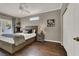 Comfortable bedroom with gray tones, wood floor, natural light, and decorative bedside lamps at 7492 Midfield Ct, Las Vegas, NV 89120