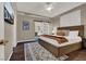 Comfortable bedroom featuring ensuite access, hardwood floor, ceiling fan and neutral paint at 7492 Midfield Ct, Las Vegas, NV 89120