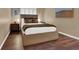 Comfortable bedroom with hardwood floors, natural light and neutral paint at 7492 Midfield Ct, Las Vegas, NV 89120