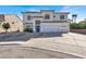 Inviting stucco two-story home with a three-car garage and a blue front door at 7492 Midfield Ct, Las Vegas, NV 89120