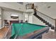 Large game room featuring a pool table, staircase, and plenty of space for entertaining at 7492 Midfield Ct, Las Vegas, NV 89120