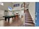 Open floor plan showcasing a game room with pool table and staircase, and view from entry at 7492 Midfield Ct, Las Vegas, NV 89120