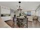Open-concept living area featuring hardwood floors and a cozy eat-in dining area at 7492 Midfield Ct, Las Vegas, NV 89120