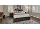 Stylish main bedroom with wood floors, cozy bedside lighting, and soothing neutral tones at 7492 Midfield Ct, Las Vegas, NV 89120