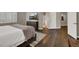 Relaxing main bedroom featuring wood floors, neutral paint, and a mounted TV above a wooden dresser at 7492 Midfield Ct, Las Vegas, NV 89120