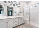 Modern bathroom featuring double sinks, white cabinets, and a spacious walk-in shower at 778 Dainty Daffodil St, Henderson, NV 89011